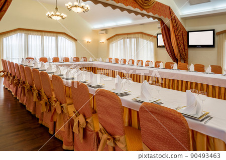 Served tables arranged in banquet hall prepared for festive celebration Served tables arranged in banquet hall prepared for festive celebration 90493463