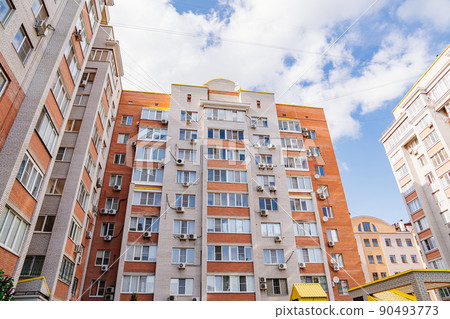 A typical brick multi-storey apartment building against the sky.  90493773
