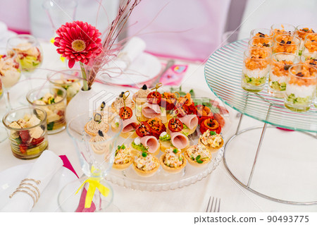 canapes on a plate. catering services for the banquet. convenient small snacks. 90493775