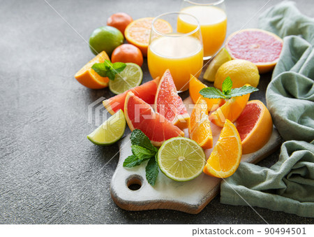 Glasses of juice and citrus fruits. Glasses of juice and citrus fruits. 90494501