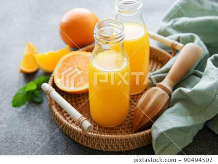 Bottles of fresh orange juice Bottles of fresh orange juice 90494502