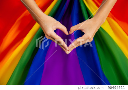 LGBTQ flag and hand heart. Pride flag symbol of Lesbian Gay Bisexsual Transgender Queer or homosexsual pride rainbow flag background LGBTQ flag and hand heart. Pride flag symbol of Lesbian Gay Bisexsual Transgender Queer or homosexsual pride rainbow flag background 90494611