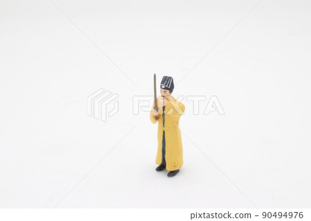 a scale of mini Taoist priest figure on board a scale of mini Taoist priest figure on board 90494976