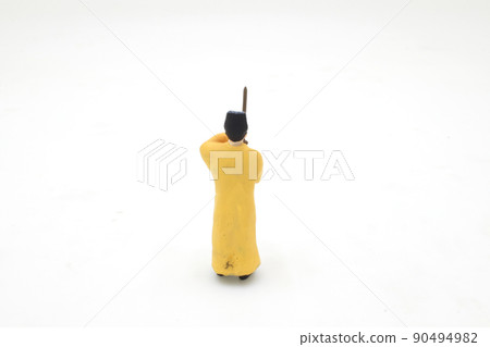 a scale of mini Taoist priest figure on board a scale of mini Taoist priest figure on board 90494982