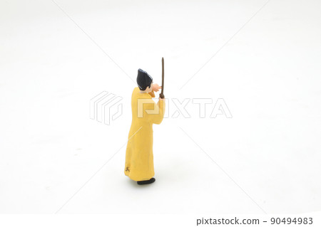 a scale of mini Taoist priest figure on board a scale of mini Taoist priest figure on board 90494983