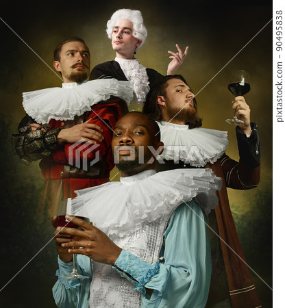 Medieval people as royalty persons in vintage clothing tasting red wine on dark vintage background. Concept of comparison of eras, modernity and renaissance, baroque style. Medieval people as royalty persons in vintage clothing tasting red wine on dark vintage background. Concept of comparison of eras, modernity and renaissance, baroque style. 90495838