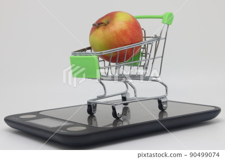 Apples on electronic kitchen scales on a white background, proper nutrition. Apples on electronic kitchen scales on a white background, proper nutrition. 90499074