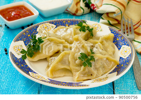 Steam the dumplings with meat and cabbage in a rustic style Steam the dumplings with meat and cabbage in a rustic style 90500756