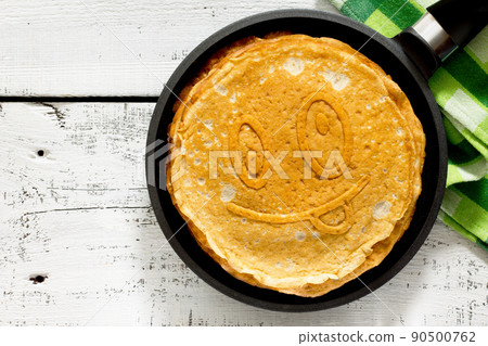 A stack of pancakes in a frying pan, traditional for Russian Carnival A stack of pancakes in a frying pan, traditional for Russian Carnival 90500762