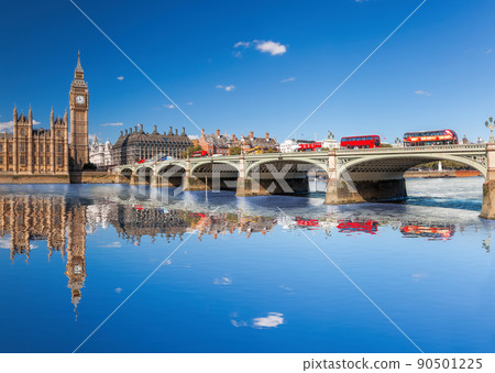 Famous Big Ben with red buses on bridge over Thames river in London, England, UKK 90501225