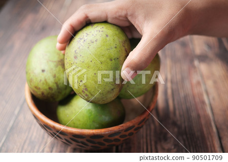 Fresh green mango in a bowl on table  90501709