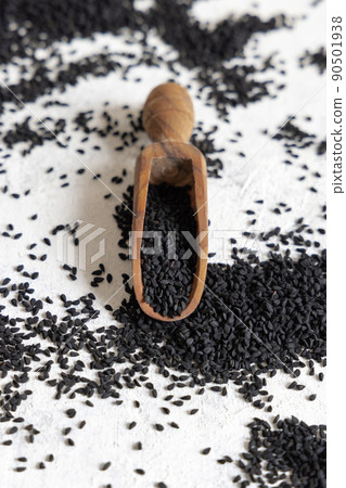 Wooden scoop of Indian spice Black cumin (nigella sativa or kalonji) seeds close up Wooden scoop of Indian spice Black cumin (nigella sativa or kalonji) seeds close up 90501938
