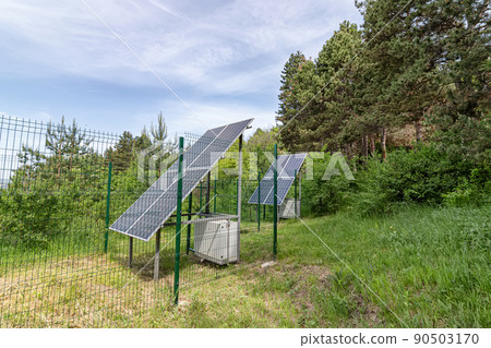 Large solar panel installed in a park area among the forest 90503170