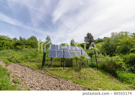 Large solar panel installed in a park area among the forest Large solar panel installed in a park area among the forest 90503174