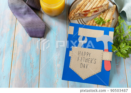 Celebrating Fathers Day. Breakfast. Fathers Day card and home DIY sandwich with bacon on wooden table. Copy space. Celebrating Fathers Day. Breakfast. Fathers Day card and home DIY sandwich with bacon on wooden table. Copy space. 90503487