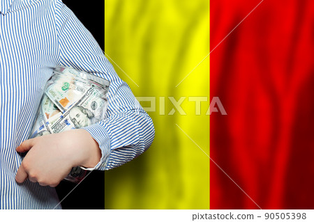 Hand holds jar of dollars cash money on Belgium flag background 90505398