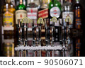 Close-up of a shots of tequila with lime and salt in a bar. 90506071