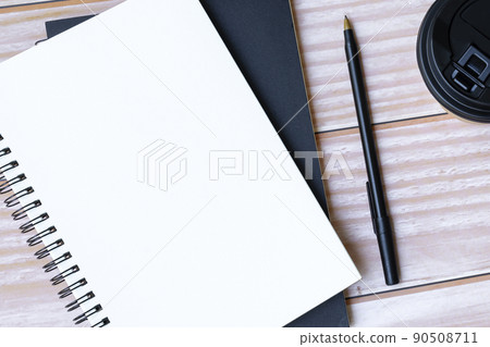 Notepad, pen, disposable and coffee cup on wooden table. Copy space. Flat lay. Notepad, pen, disposable and coffee cup on wooden table. Copy space. Flat lay. 90508711