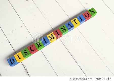Discrimination word on colorful wooden block cube. 90508712