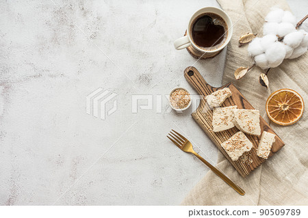 Sliced tahini halva on a wooden board, flat lay 90509789