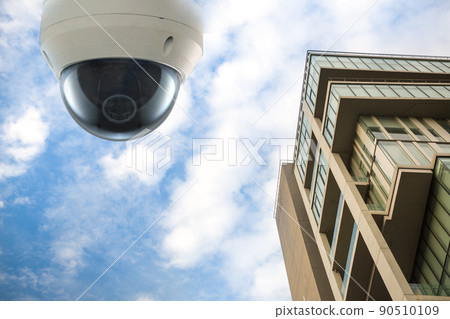 Outdoor CCTV Security camera installed on the building wall in the city. 90510109
