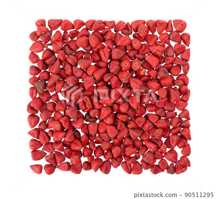 Annatto seeds, isolated on a white background. Achiote seeds, bixa orellana. Natural dye for cooking and food. Close-up. Top view. 90511295