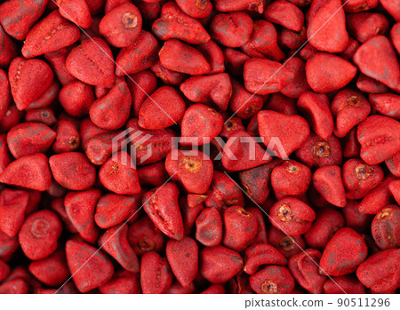 Annatto seeds background. Achiote seeds, bixa orellana. Natural dye for cooking and food. Close-up. Top view. 90511296