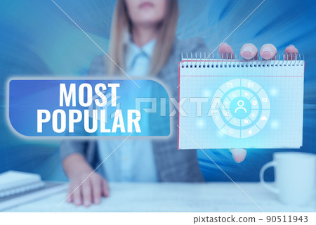 Text caption presenting Most Popular. Concept meaning Liked Followed Enjoyed by majority of the showing in a society Lady Pressing Screen Of Mobile Phone Showing The Futuristic Technology Text caption presenting Most Popular. Concept meaning Liked Followed Enjoyed by majority of the showing in a society Lady Pressing Screen Of Mobile Phone Showing The Futuristic Technology 90511943