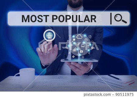 Text sign showing Most Popular. Word for Liked Followed Enjoyed by majority of the showing in a society Man holding Screen Of Mobile Phone Showing The Futuristic Technology. 90511975