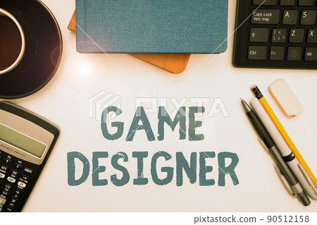 Hand writing sign Game Designer. Word for Campaigner Pixel Scripting Programmers Consoles 3D Graphics Office Supplies Over Desk With Keyboard And Glasses And Coffee Cup For Working Hand writing sign Game Designer. Word for Campaigner Pixel Scripting Programmers Consoles 3D Graphics Office Supplies Over Desk With Keyboard And Glasses And Coffee Cup For Working 90512158