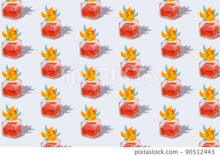 Bottles of red perfume lined up in a pattern on a white background. Plugs made of shaped multicolored plasticine Bottles of red perfume lined up in a pattern on a white background. Plugs made of shaped multicolored plasticine 90512443
