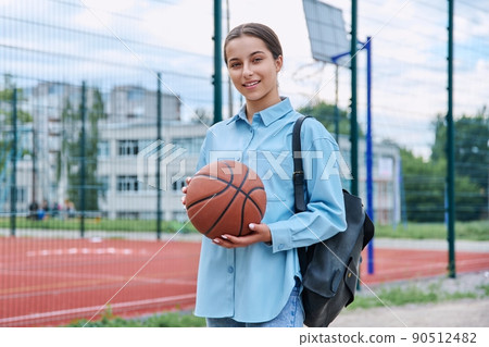 Portrait of teenage student girl with backpack and basketball ball 90512482