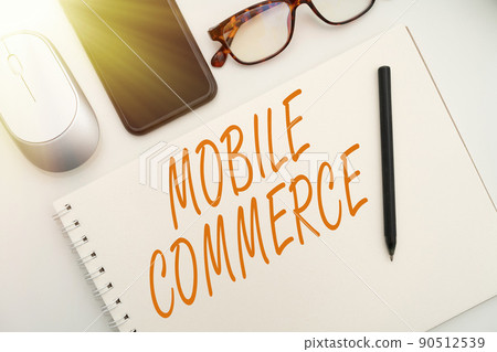 Text sign showing Mobile Commerce. Word Written on Using mobile phone to conduct commercial transactions online Office Supplies Over Desk With Keyboard And Glasses And Coffee Cup For Working Text sign showing Mobile Commerce. Word Written on Using mobile phone to conduct commercial transactions online Office Supplies Over Desk With Keyboard And Glasses And Coffee Cup For Working 90512539