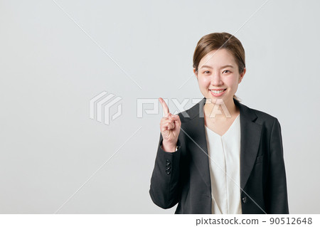 A business woman in a jacket with her index finger A business woman in a jacket with her index finger 90512648