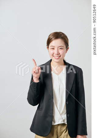 A business woman in a jacket with her index finger 90512649