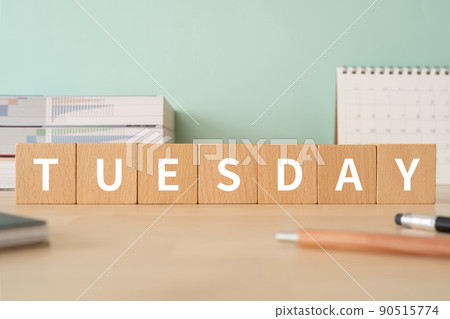 Tuesday image | Desk with a block labeled "TUESDAY" 90515774