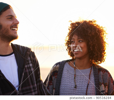 Oh, you think youre funny.... Shot of a young couple enjoying a walk on the beach. Oh, you think youre funny.... Shot of a young couple enjoying a walk on the beach. 90516284