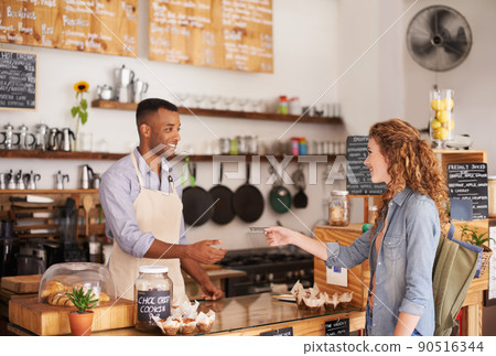 The coolest cafe in town. Shot of two people in a cafe. 90516344