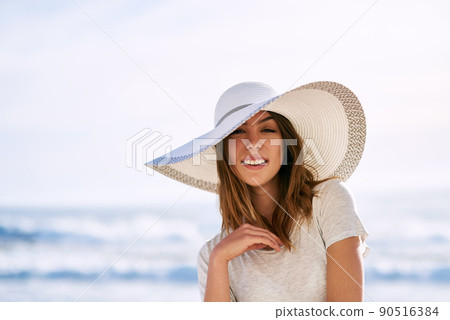 Get outside and enjoy the fresh air. Cropped shot of a beautiful young woman posing on the beach. Get outside and enjoy the fresh air. Cropped shot of a beautiful young woman posing on the beach. 90516384