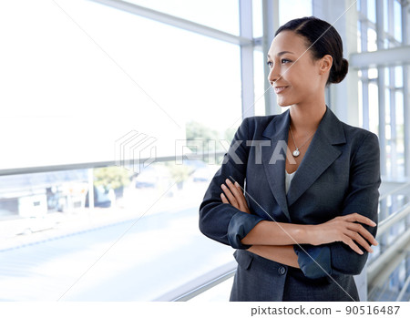 Focused on success. An attractive businesswoman standing in an office environment. 90516487