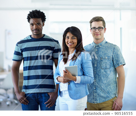 The best in the business. Cropped portrait of three coworkers standing in the office. 90516555