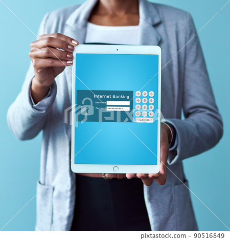 Pay your accounts on your digital tablet. Studio shot of an unrecognizable woman holding a tablet displaying an internet banking webpage against a blue background. 90516849