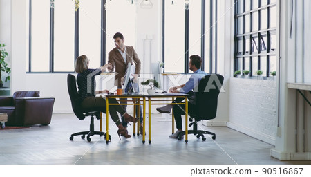 Welcome to the team. Full length shot of a group of designers working together in their creative office. 90516867