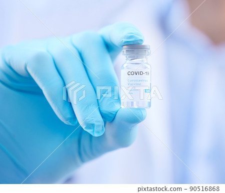 She really does have the whole world in her hands. Cropped shot of an unrecognizable doctor holding a corona virus vaccine outside. She really does have the whole world in her hands. Cropped shot of an unrecognizable doctor holding a corona virus vaccine outside. 90516868