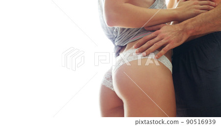 It's tempting. Cropped shot of an unrecognizable couple getting intimate against a white background. 90516939