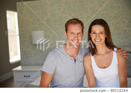 We complete each other perfectly. Portrait of a mature couple relaxing together in their bedroom. We complete each other perfectly. Portrait of a mature couple relaxing together in their bedroom. 90518164