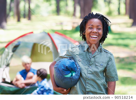 He loves camping. A boy standing in front of his campsite. He loves camping. A boy standing in front of his campsite. 90518214