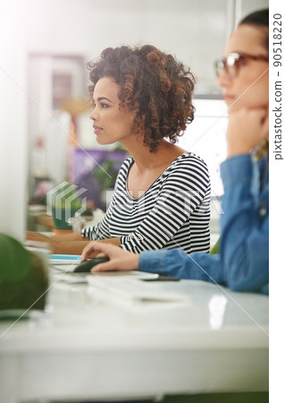Full focused. Cropped shot of two young businesswomen at their desks. Full focused. Cropped shot of two young businesswomen at their desks. 90518220