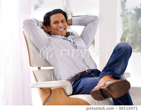 Hes ready for the work day. A handsome young businessman in his home. Hes ready for the work day. A handsome young businessman in his home. 90518471