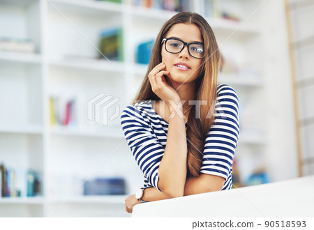 Portrait of a young woman wearing glasses relaxing at home 90518593